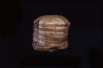 Woven cylindrical container with damage featured in Discover The Most Expensive Aged Tea article