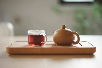 Tea set on wooden tray for quality check of Pu Erh tea
