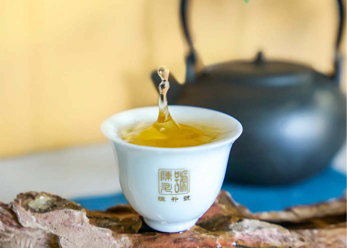 White teacup with golden tea splash for healthy tea consumption tips article