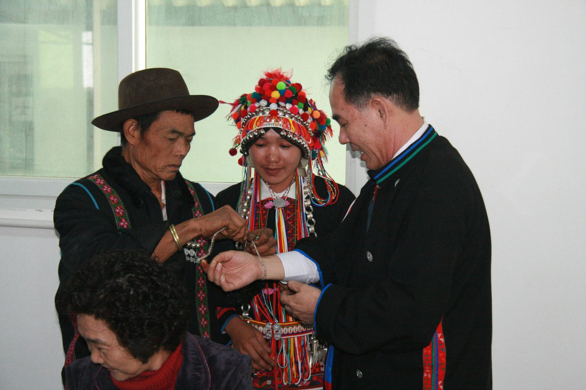 Hani elders tie a blessing thread on Shenghe Chen’s wrist in Lao Ban Zhang, 2011