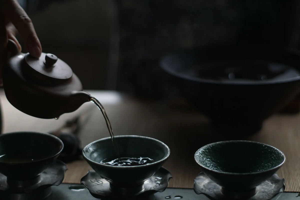 Tea being poured into cups for traditional Pu Erh tea ceremony