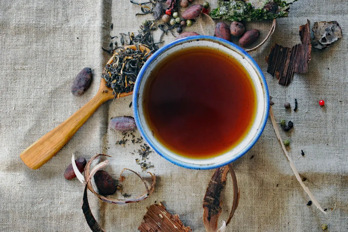 Cup of dark tea in a mug showcasing a caffeine comparison between Tea and Coffee