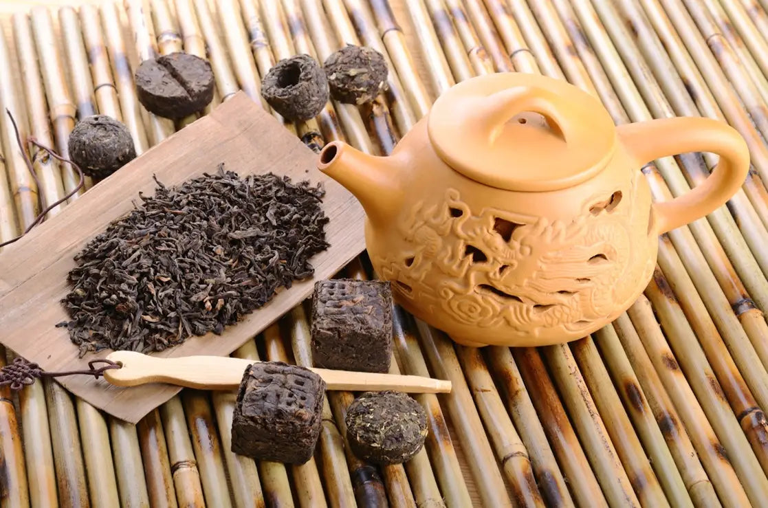 Ornate light brown teapot used in Pu-Erh tea brewing guide