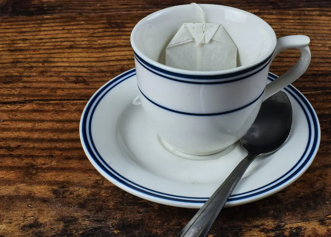 White teacup with blue stripes on a wooden table front view