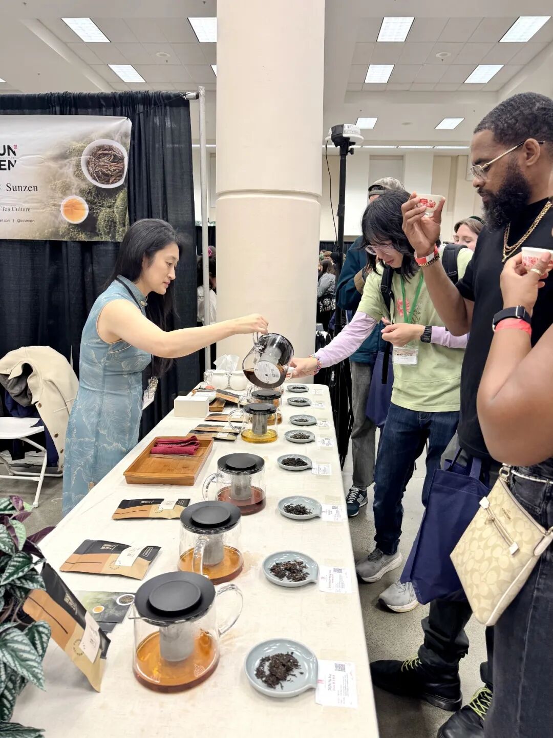 Pouring tea for visitors at the tasting table