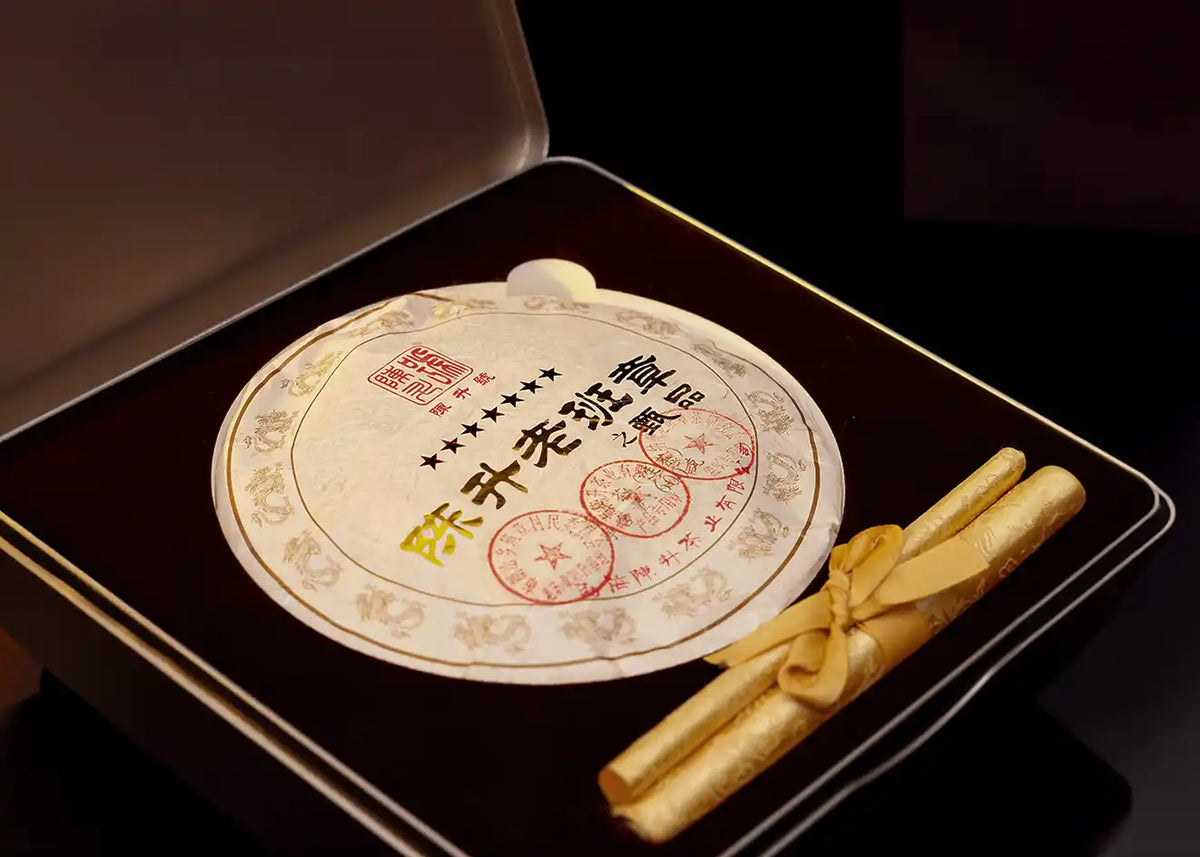 A Chen Sheng Lao Ban Zhang pu-erh cake in a black gift box