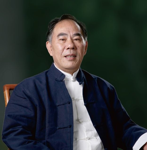 Portrait of founder Shenghe Chen in a traditional jacket