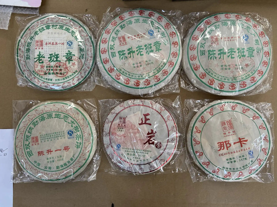 Six wrapped Chen Sheng Hao pu-erh cakes, including Lao Ban Zhang and Na Ka