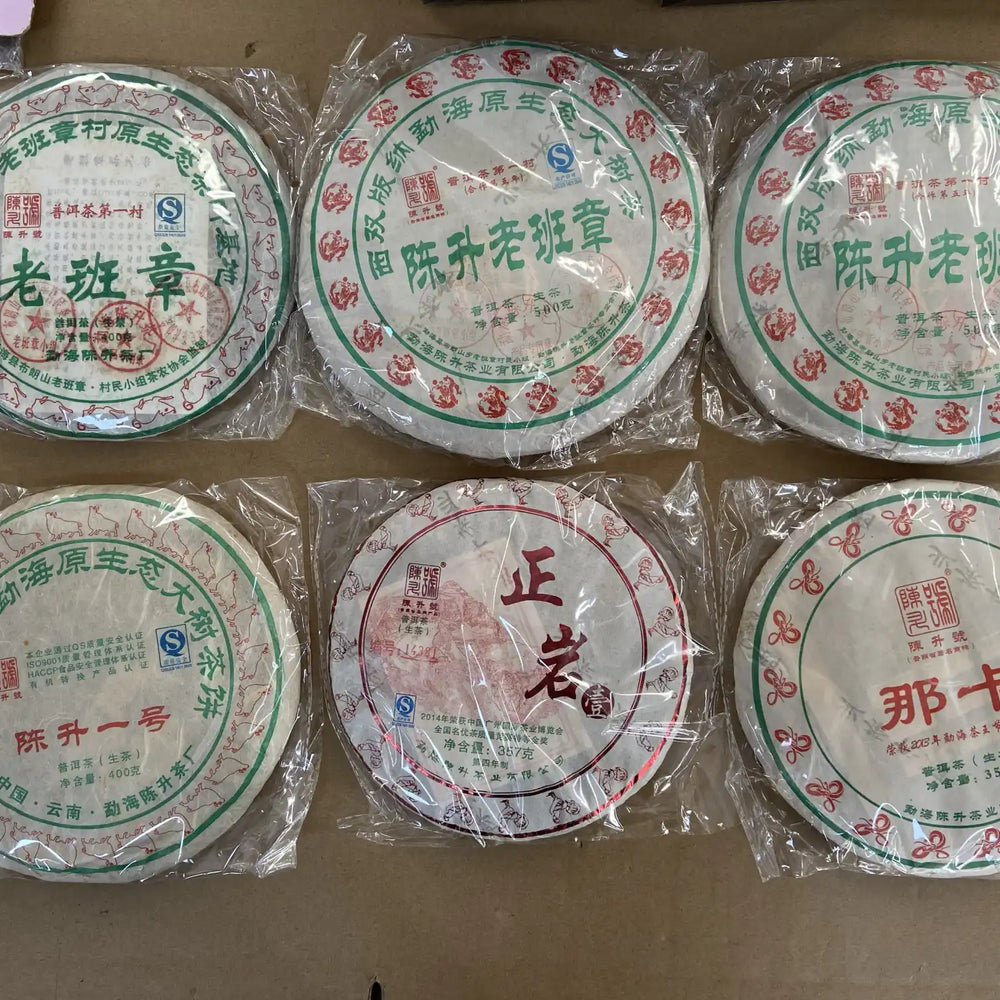 Six individually wrapped, round cakes of Pu-erh tea.