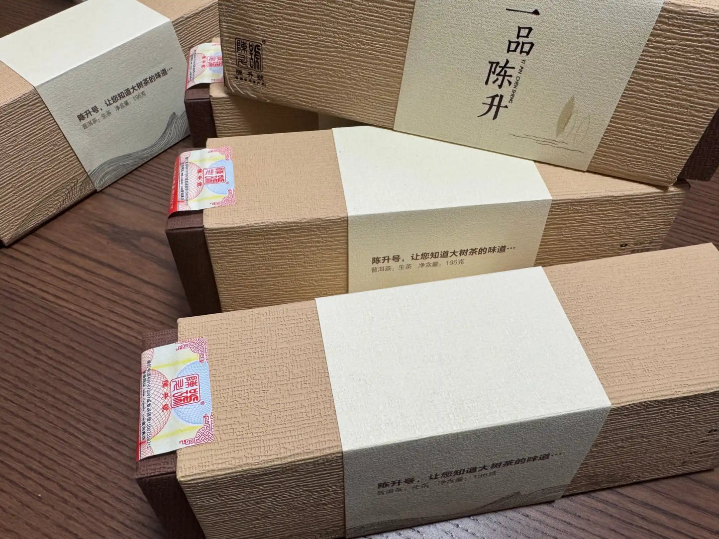 Stacked, brown, textured gift boxes with light-colored bands.