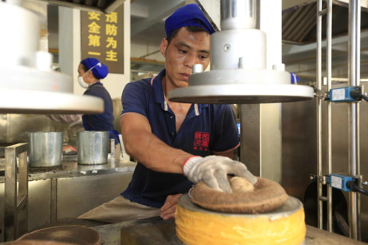 Step 10: Pressing tea cakes by machine